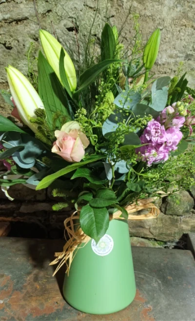Seasonal Breeze Eco Vase - A seasonal selection of blooms arranged in a recycled or reused vase.  We source previously used containers and you can then reuse, recycle or donate them to help save on waste.  As the containers have had a life previously they may have small marks or scratches but nothing to spoil their beauty for anyone looking to be more environmentally aware.
