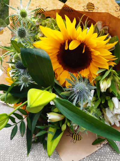 Sunny Smile - A beautiful bunch of bright, sunny blooms, wrapped in kraft paper and tied with raffia